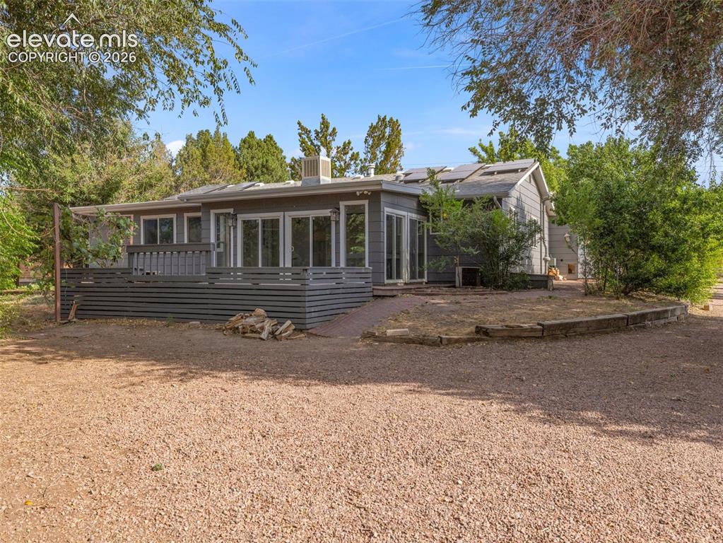 Image 28 of 35: Exterior featuring a gray siding facade, a spacious deck with horizontal sl