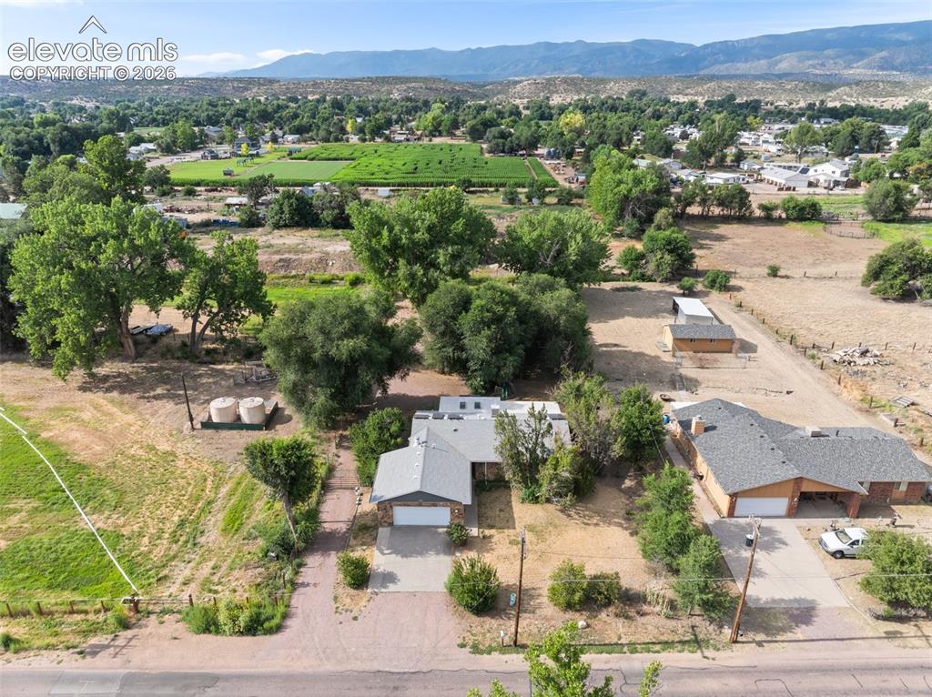 Image 32 of 35: Expansive rural property featuring a single-story residence with an attache