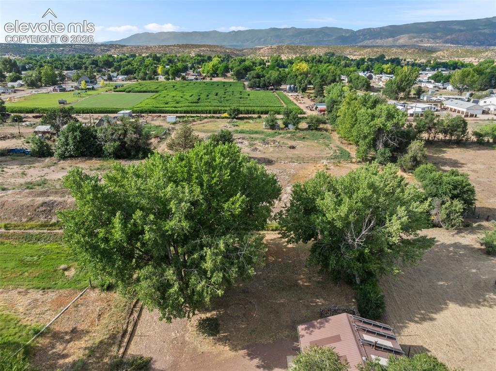 Image 33 of 35: Expansive rural landscape featuring a prominent agricultural field, distant