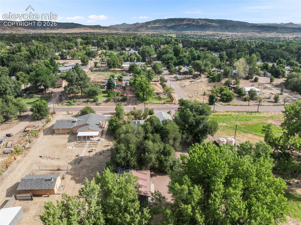 Image 34 of 35: Expansive property with a single-story residence and detached outbuilding