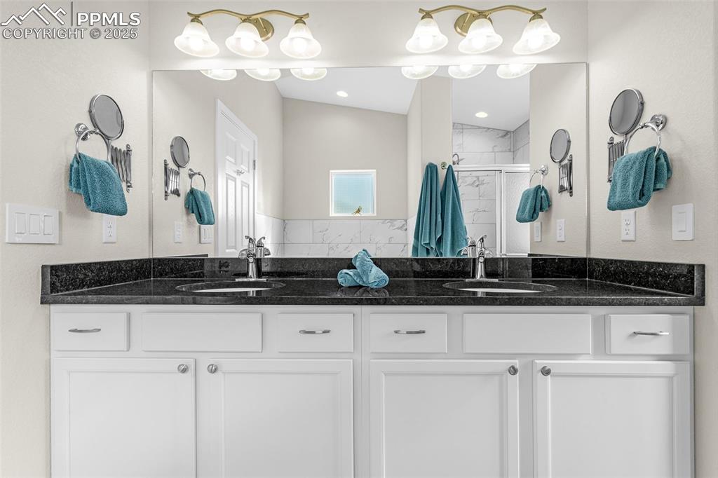 Image 18 of 37: Full bathroom featuring double vanity, a tile shower, and soaker tub.