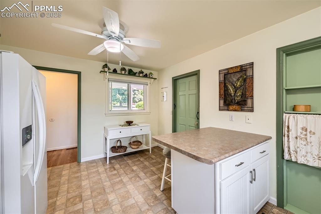 Image 13 of 33: Kitchen featuring white fridge with ice dispenser, white cabinets, ceiling 