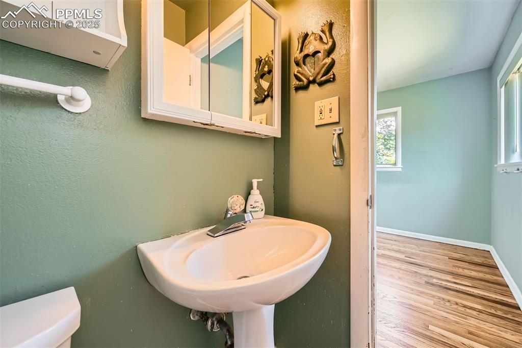 Image 19 of 33: Bathroom with wood finished floors and toilet