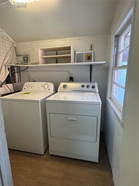 Image 32 of 33: Laundry room with washing machine and clothes dryer and carpet floors