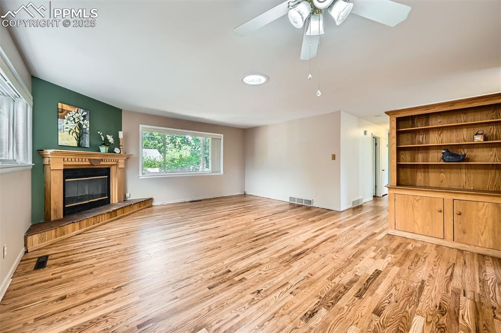Image 7 of 33: Built ins and cozy Fireplace