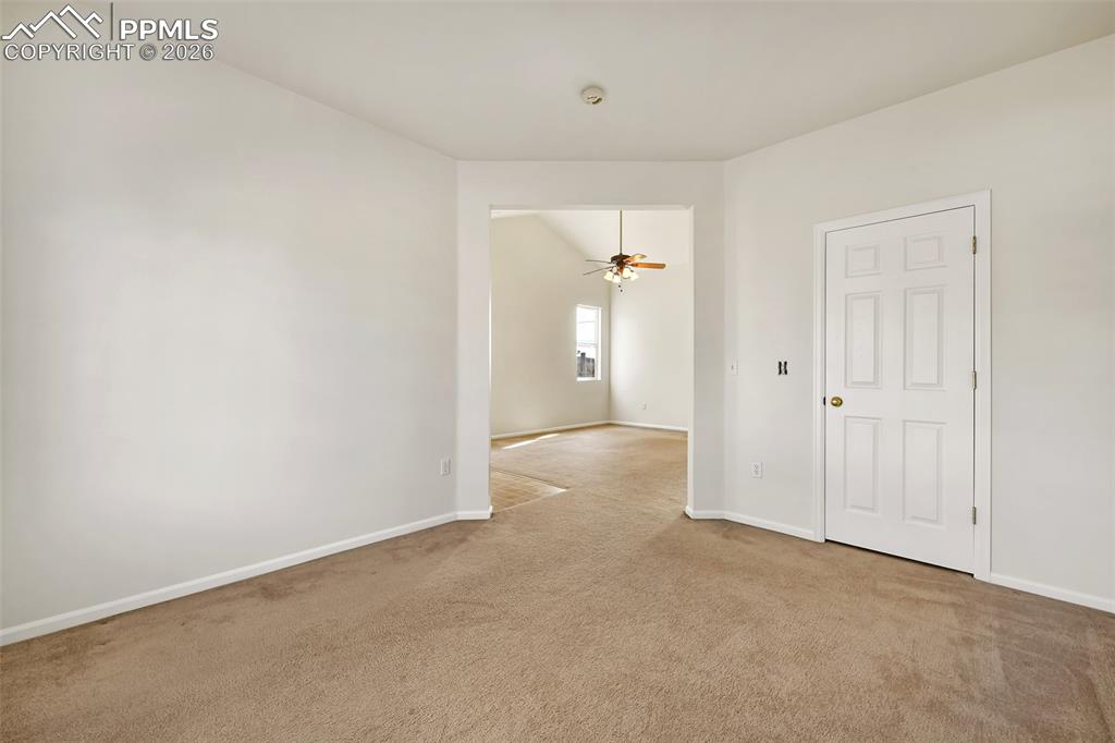 Image 10 of 28: Unfurnished room with carpet floors and ceiling fan