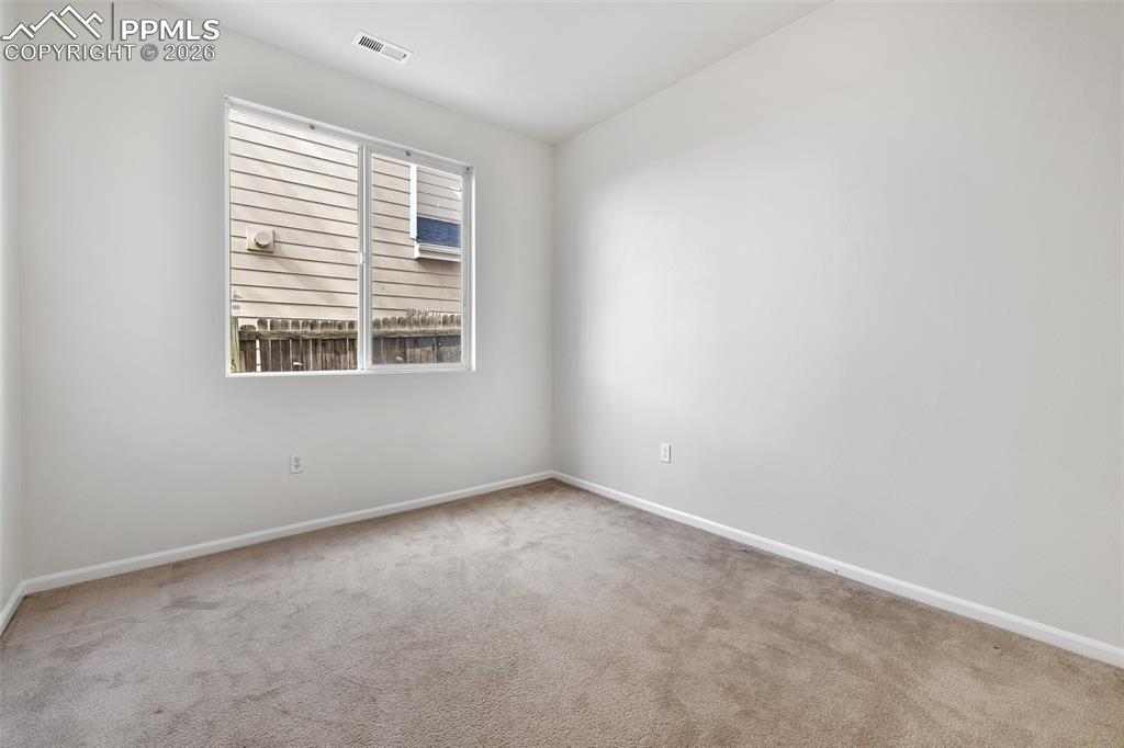 Image 15 of 28: Carpeted spare room featuring baseboards