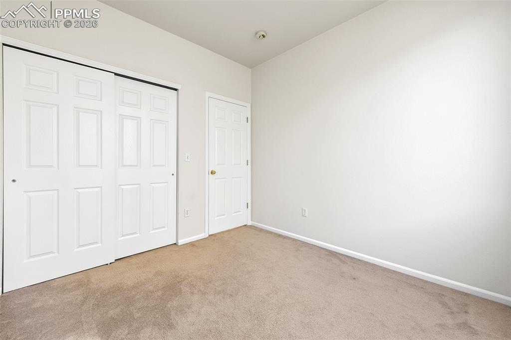 Image 16 of 28: Unfurnished bedroom with carpet floors and a closet