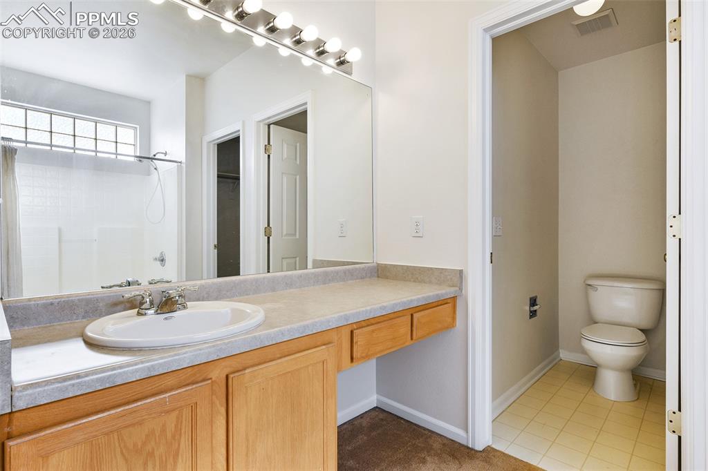 Image 19 of 28: Full bathroom with vanity, a shower, and light tile patterned flooring