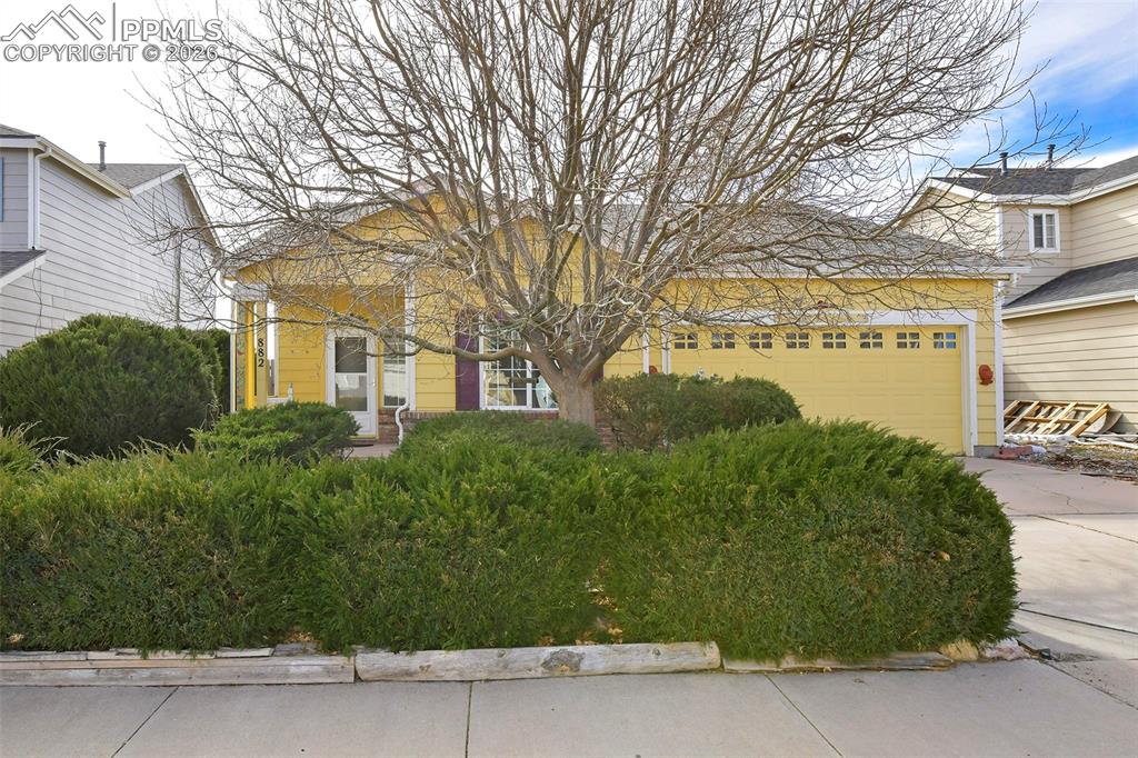 Image 2 of 28: View of front of home featuring driveway and an attached garage