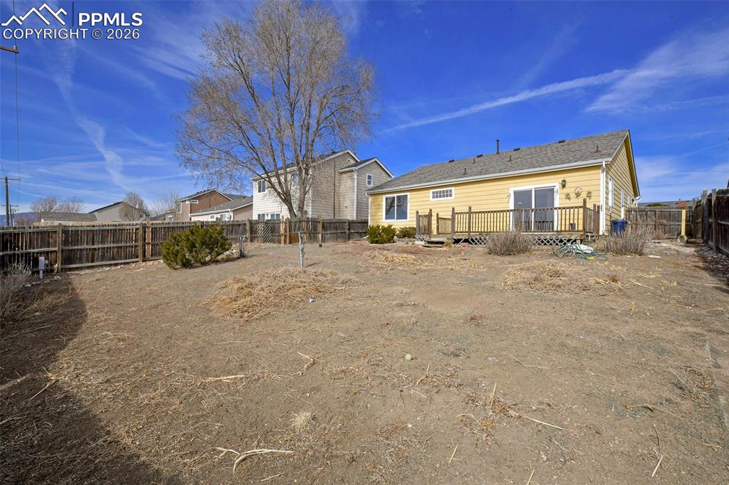 Image 27 of 28: Back of house with a wooden deck and a fenced backyard