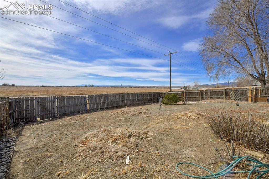 Image 28 of 28: View of fenced backyard