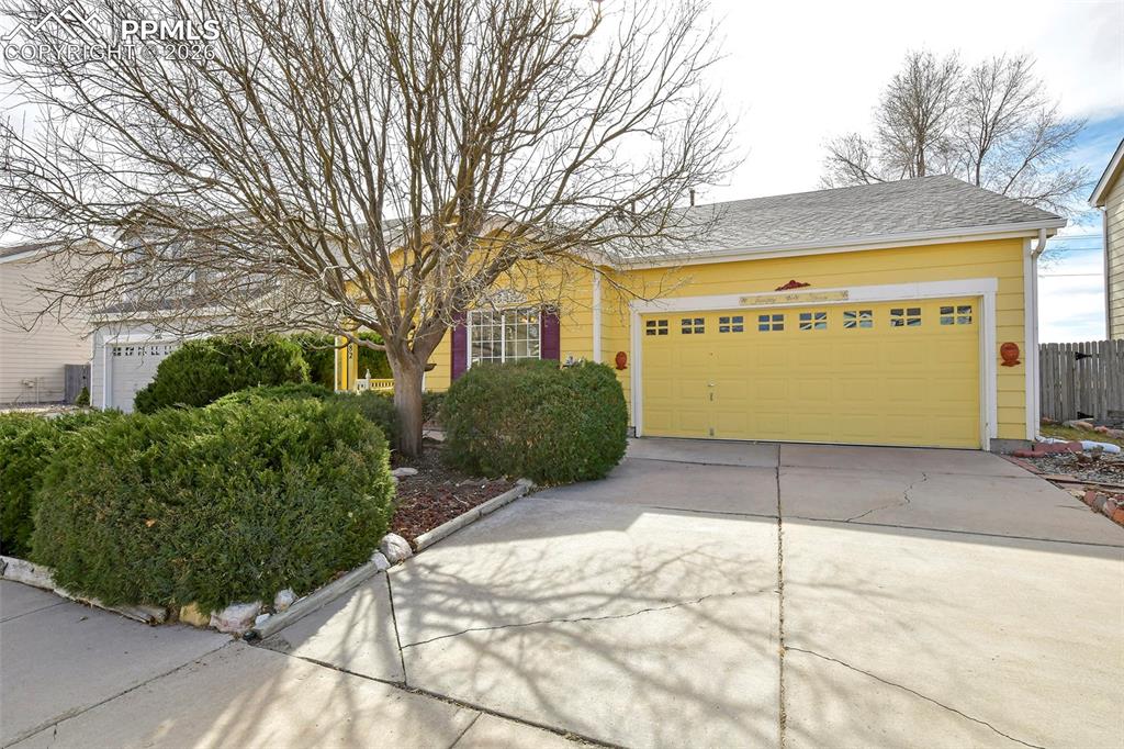 Image 3 of 28: View of front facade with a garage and driveway