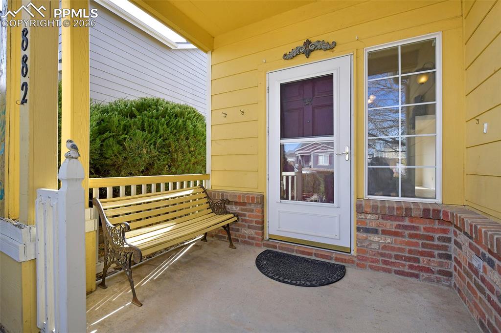 Image 4 of 28: Property entrance featuring brick siding