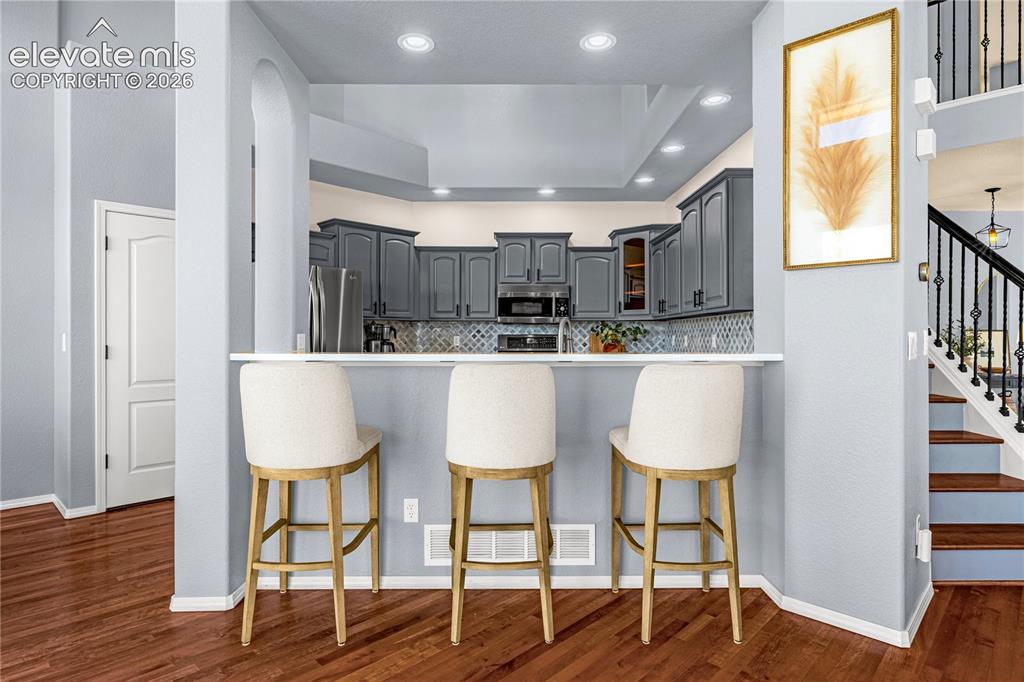 Image 12 of 41: Bonus seating at the kitchen counter
