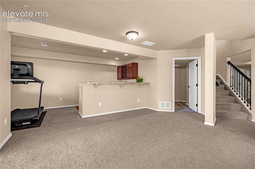 Image 32 of 41: Basement Rec Room & wet bar