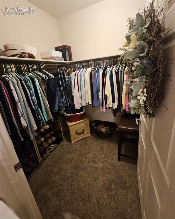 Image 16 of 24: 8 X 8 walk in closet off of primary bath/bedroom