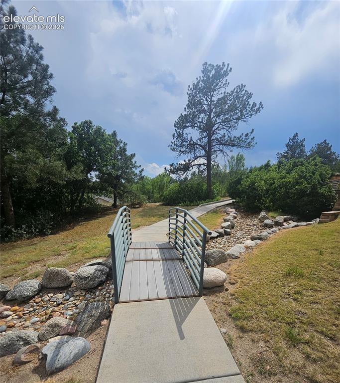 Image 3 of 24: path to back of building with access to hiking and biking trails in Palmer