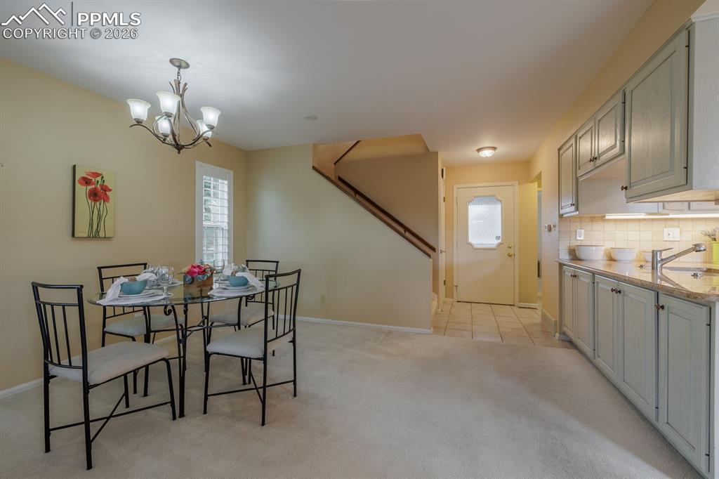 Image 10 of 47: Front hall into dining area. Custom cabinets add an abundance of storage on