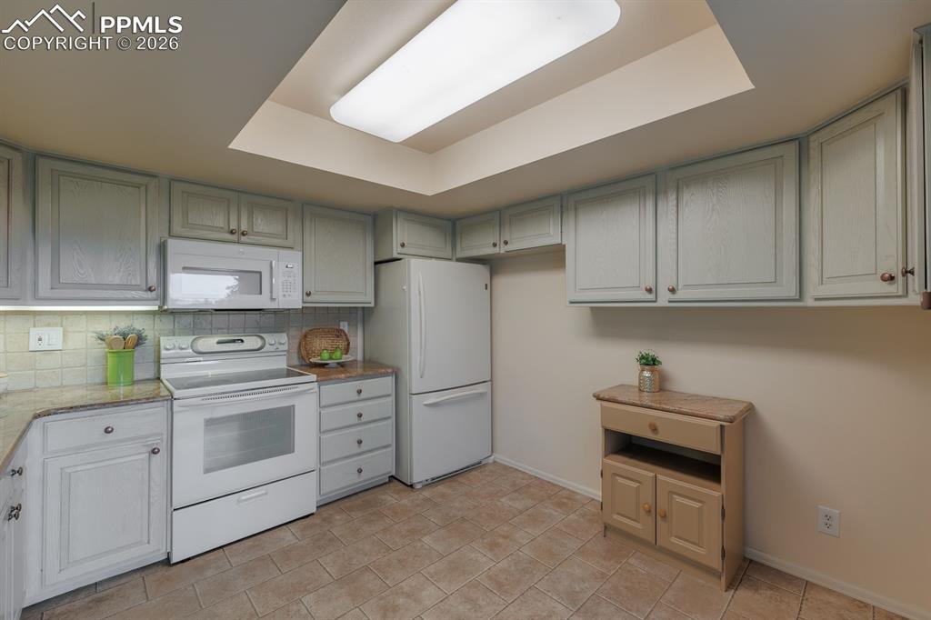 Image 15 of 47: custom cabinetry and trey ceiling, under counter lighting
