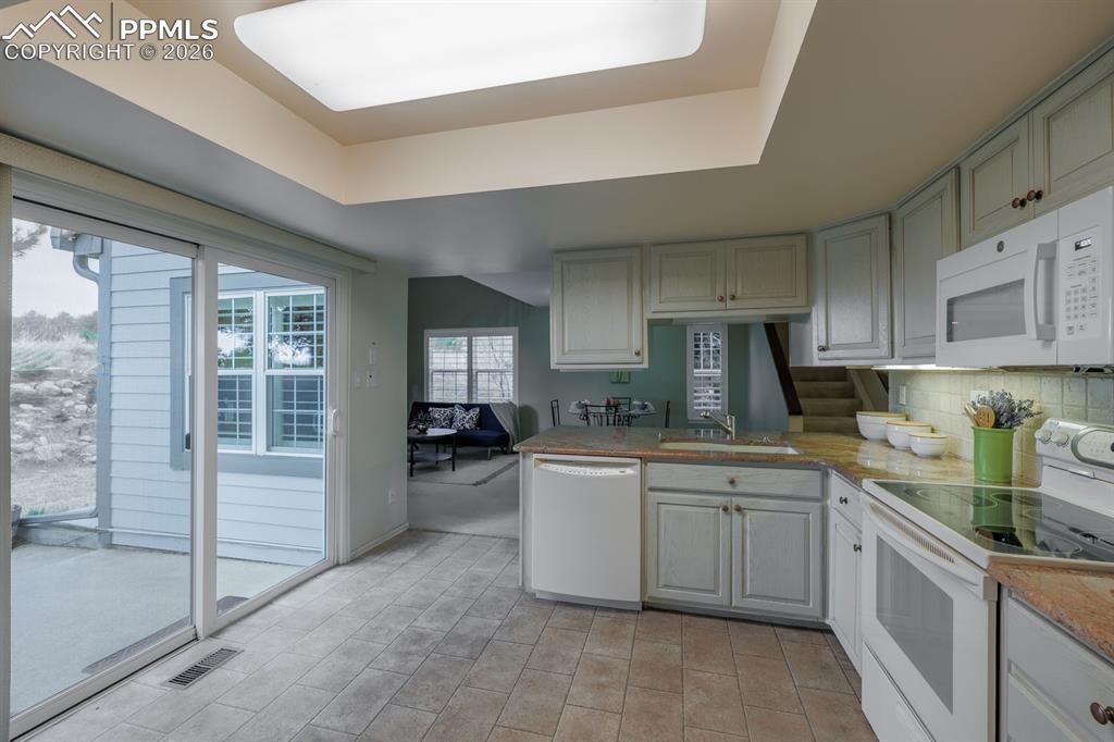 Image 17 of 47: New slider and patio off the kitchen