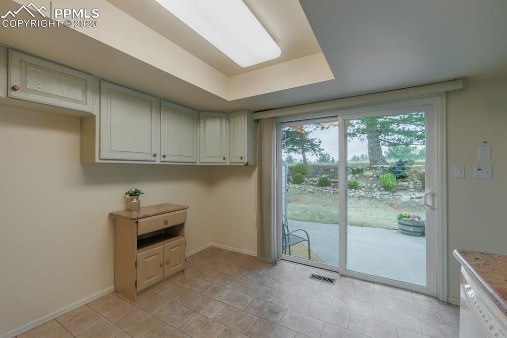 Image 18 of 47: Abundance of light in the kitchen and nature at your back door