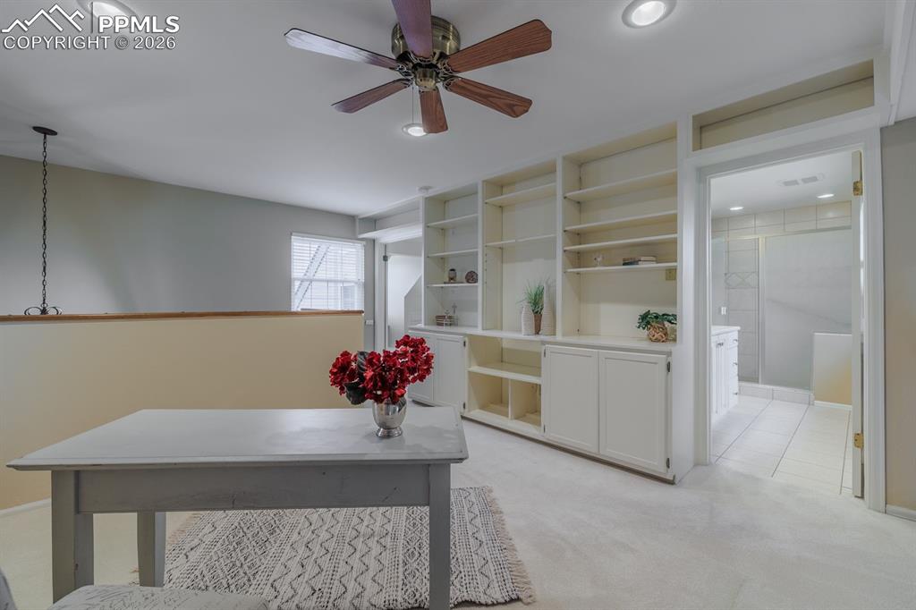 Image 22 of 47: Built in bookcases and view of Cheyenne mountain. Could be used as an offic