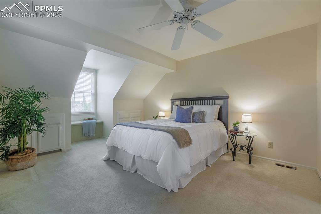 Image 24 of 47: Primary bedroom off the loft with a wonderful window seat to gaze at mounta