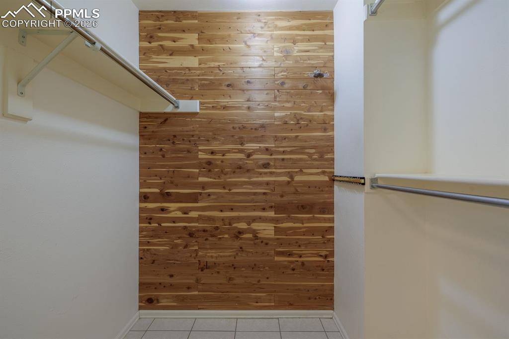 Image 28 of 47: Cedar lined walk in closet off of primary bedroom in primary bathroom