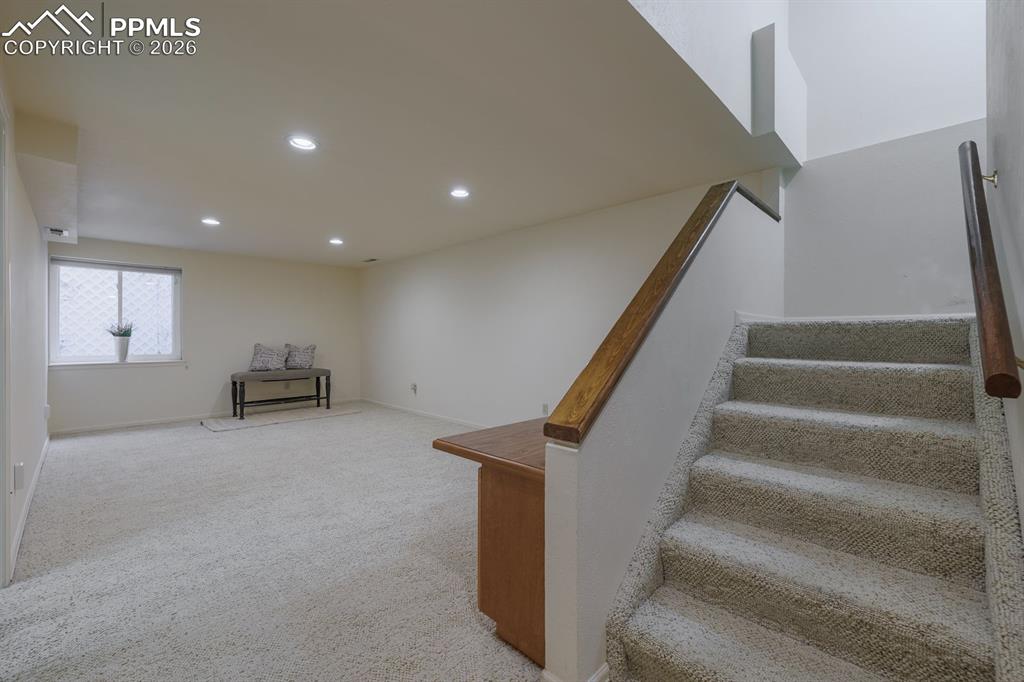 Image 29 of 47: Basement family room with built in desk area that can serve as a craft area