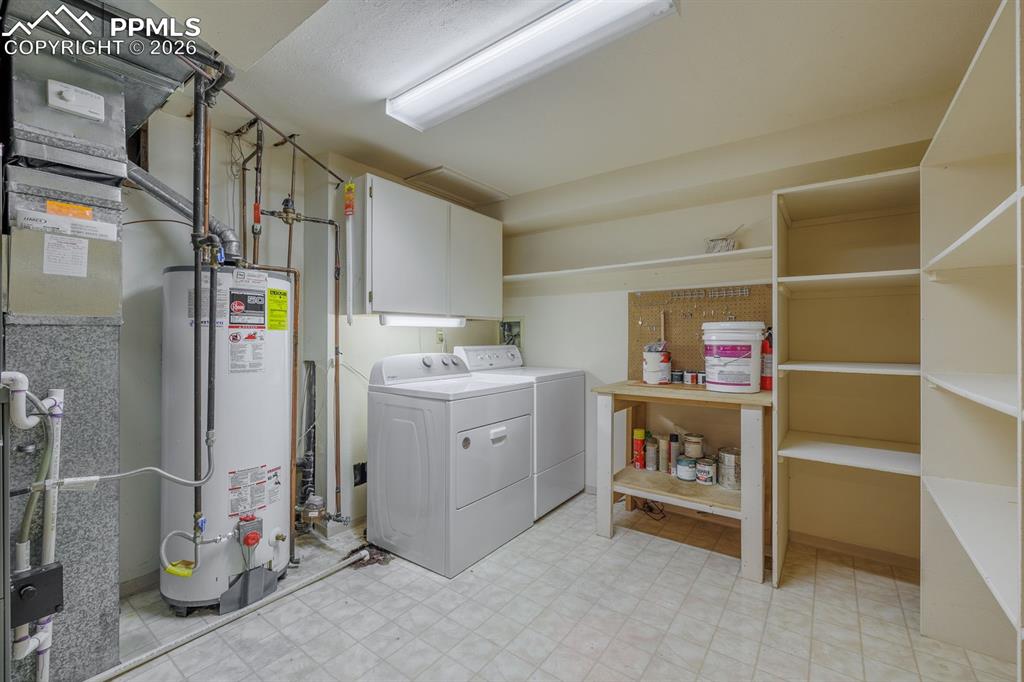 Image 32 of 47: Great storage and work area in laundry room with under dryer lighting