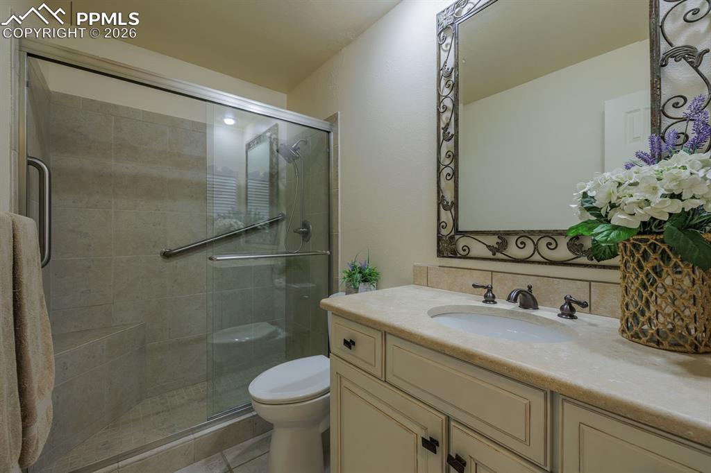 Image 9 of 47: Updated bath adjacent to main level bedroom updated spa like shower and sla