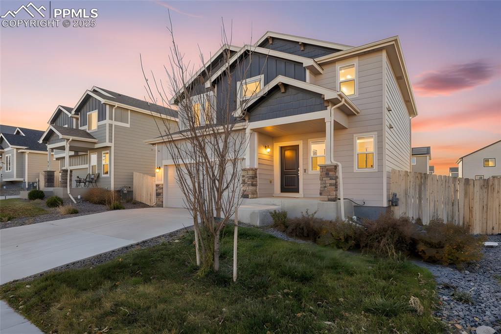 Image 14 of 48: Craftsman inspired home with board and batten siding, concrete driveway, a