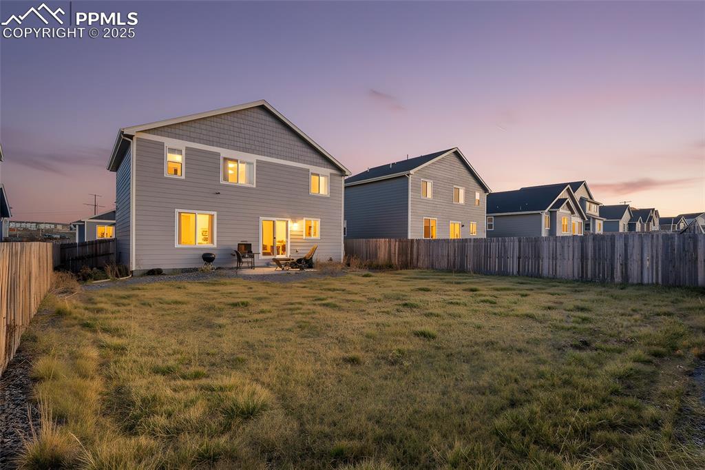 Image 15 of 48: Rear view of house with a patio area and a fenced backyard