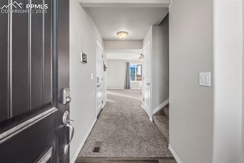 Image 16 of 48: Hallway featuring baseboards and carpet