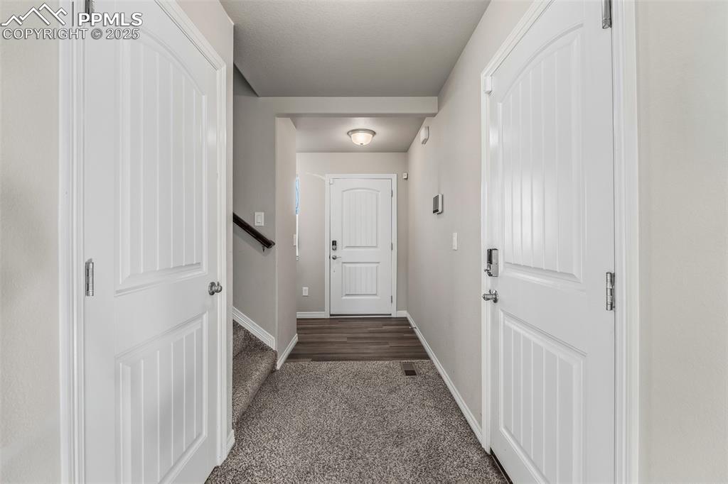 Image 17 of 48: Doorway with carpet flooring and baseboards