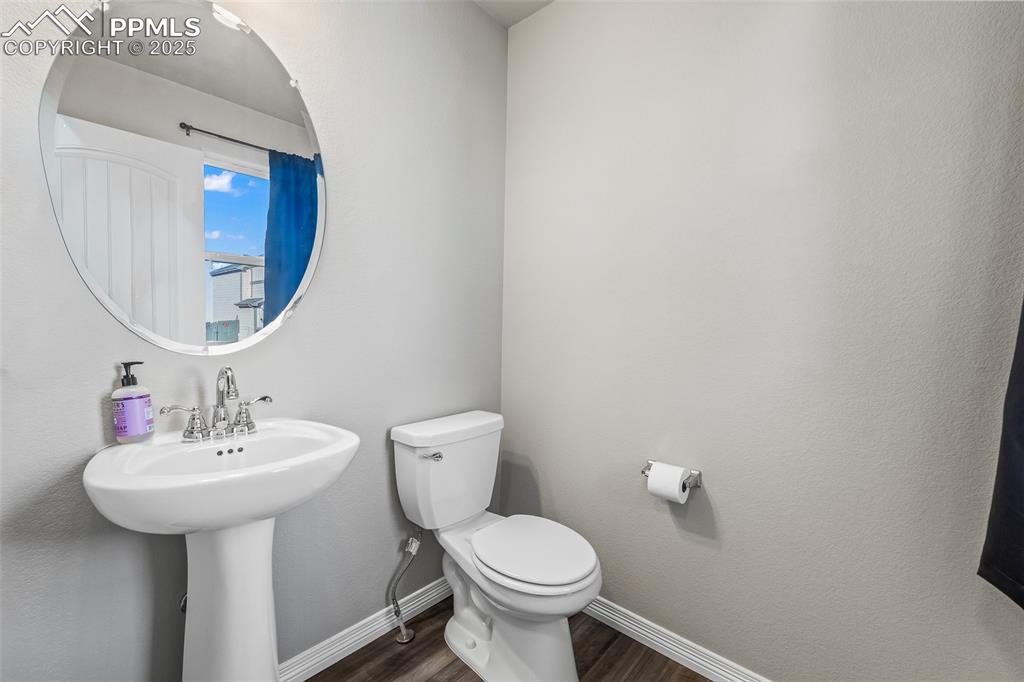 Image 18 of 48: Bathroom featuring dark wood finished floors and toilet