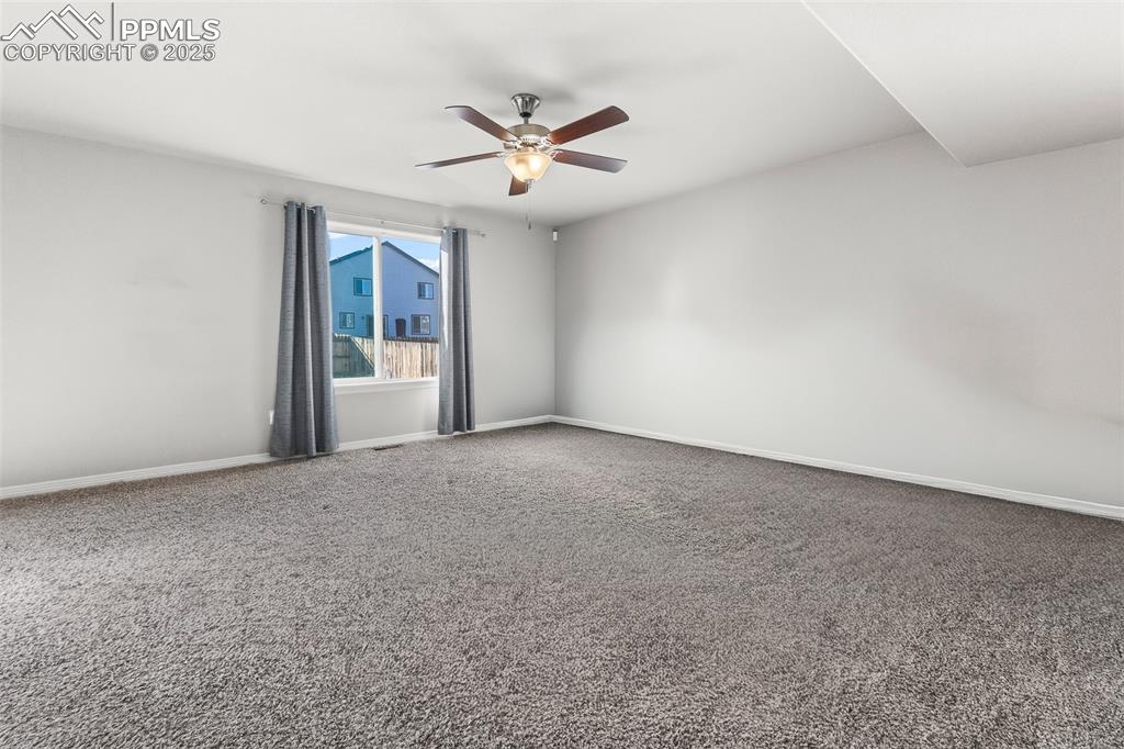 Image 19 of 48: Unfurnished room with carpet and ceiling fan