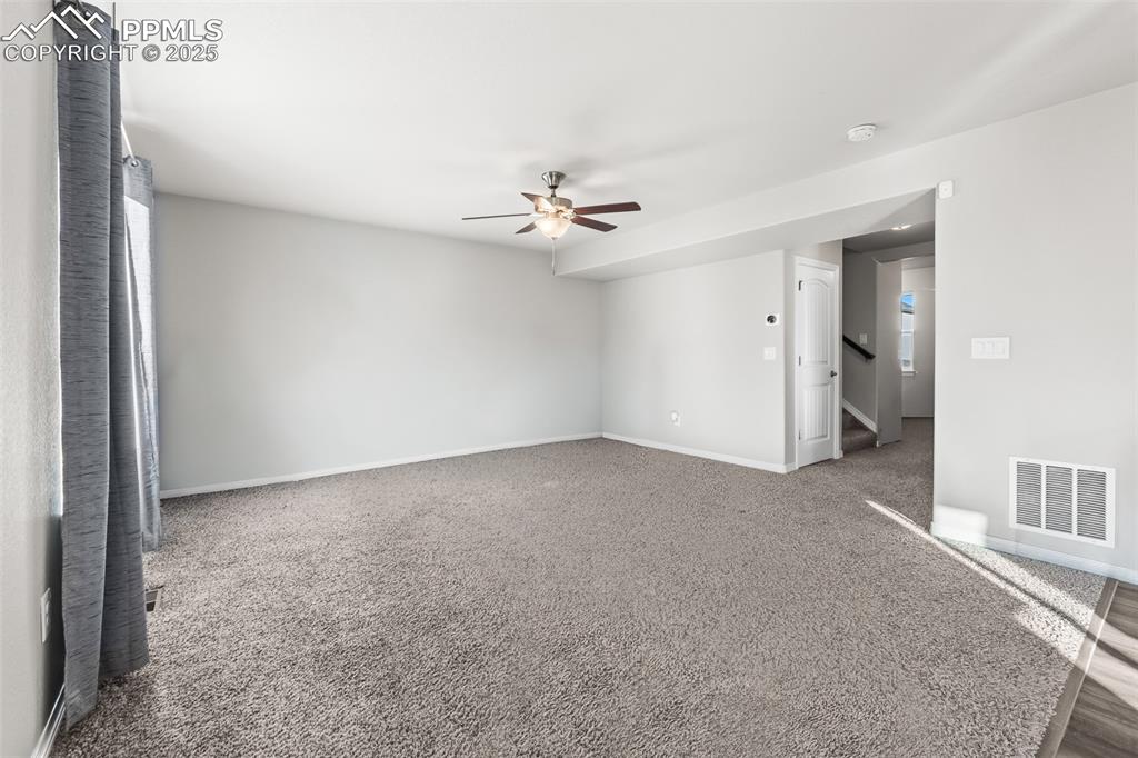 Image 21 of 48: Unfurnished room featuring carpet flooring and ceiling fan