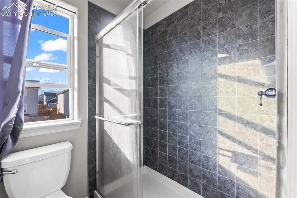 Image 38 of 48: Bathroom featuring a stall shower