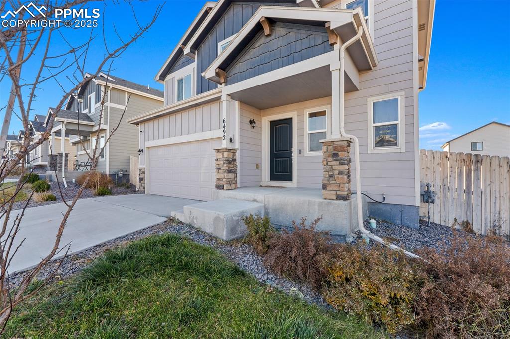 Image 4 of 48: Craftsman inspired home with board and batten siding, driveway, stone sidin