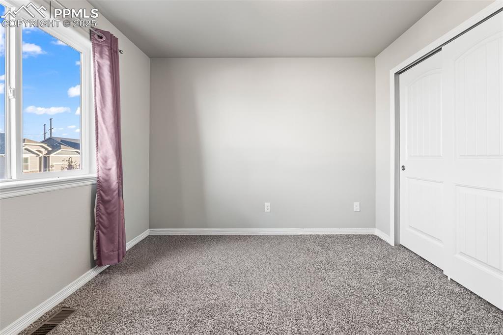 Image 44 of 48: Unfurnished bedroom featuring carpet and a closet