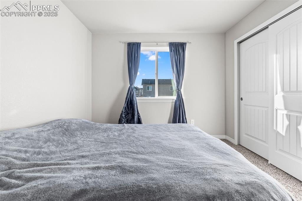 Image 48 of 48: Bedroom with carpet floors and a closet