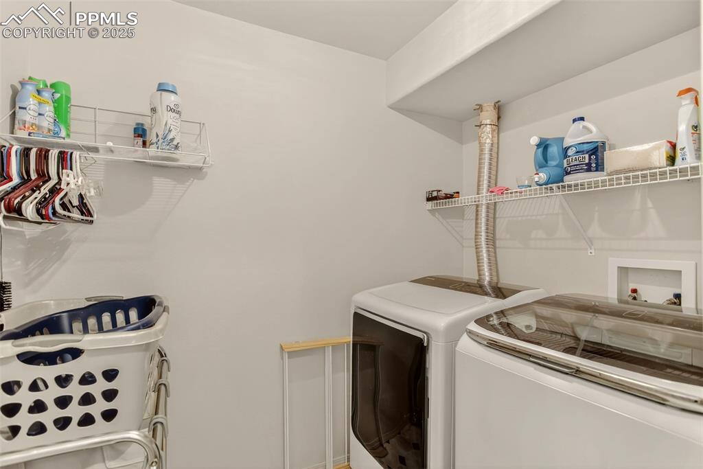 Image 27 of 38: Washroom with separate washer and dryer