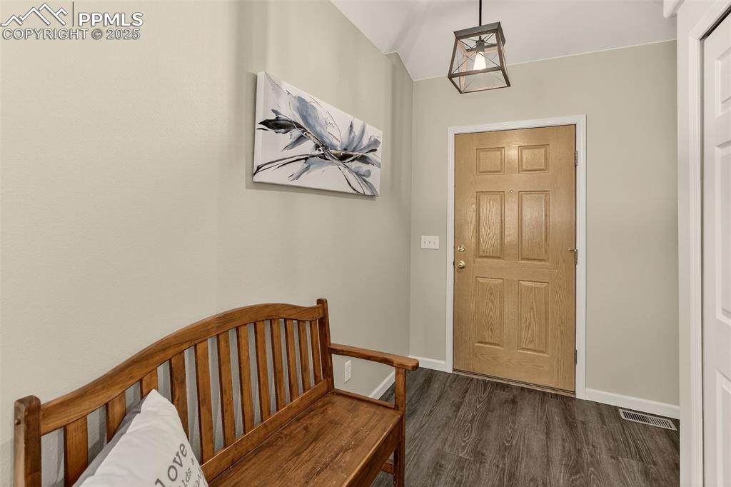 Image 7 of 38: Entrance foyer featuring dark wood finished floors and baseboards