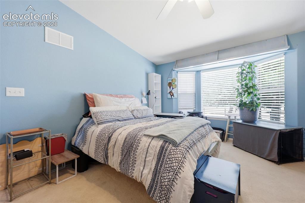Image 13 of 49: Carpeted room featuring a bay window with horizontal blinds, a sloped ceili