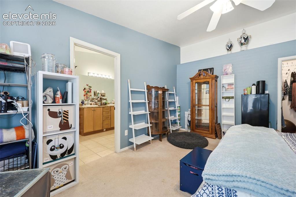 Image 15 of 49: Spacious room with light blue wall paint, light neutral carpet flooring, an