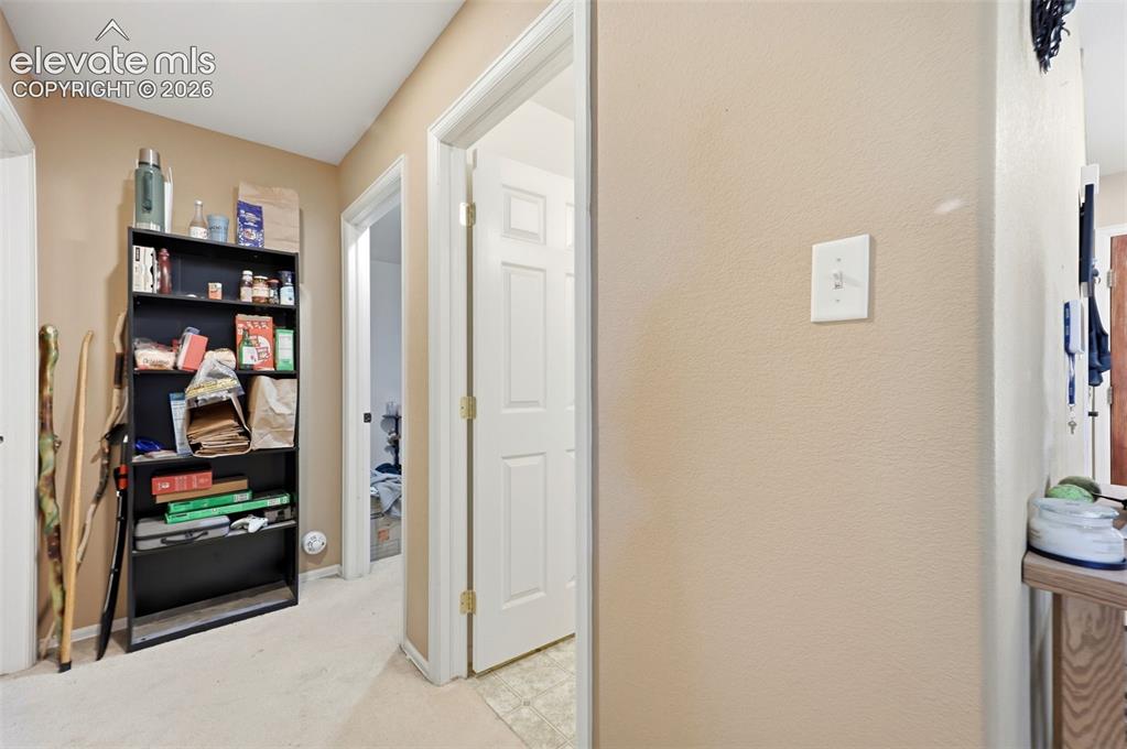 Image 18 of 49: Hallway featuring light-toned walls, white trim, and carpet flooring