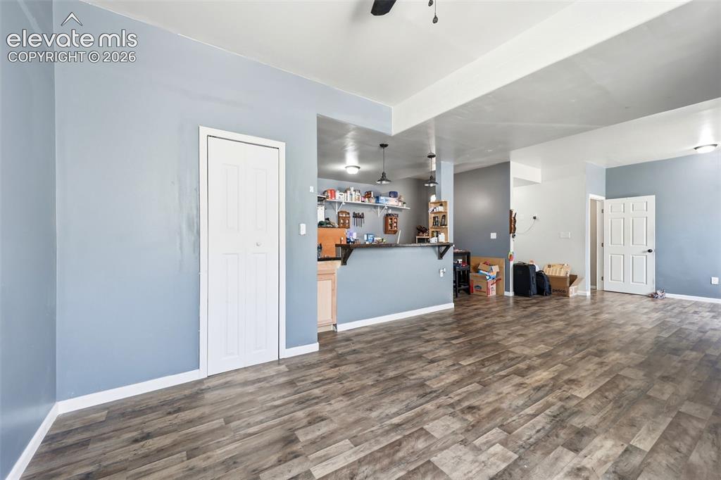 Image 26 of 49: Spacious interior featuring wood-finish flooring, light blue wall paint, an