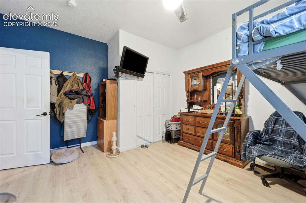 Image 29 of 49: Bright interior space featuring light wood-finish flooring, a white ceiling